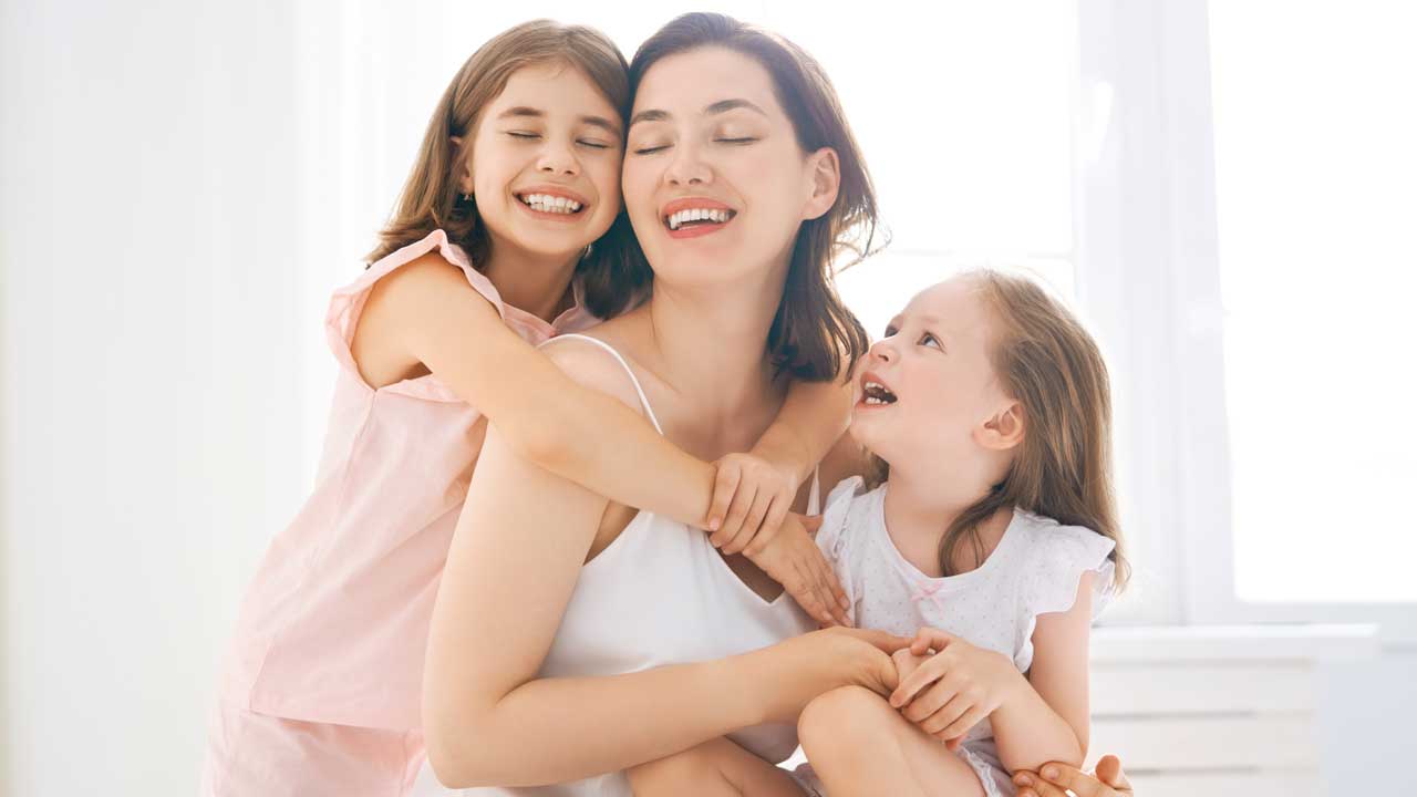 Happy mother after mommy makeover abroad with Starwise